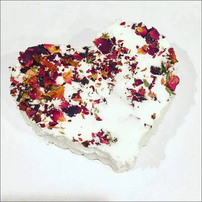 Heart-shaped rose bath bomb with organic ingredients and colorful petals.